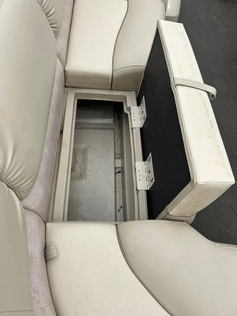 Slide: The Image of 2014 Bennington 2550 RCL boat seat storage compartment, open and empty. - 19