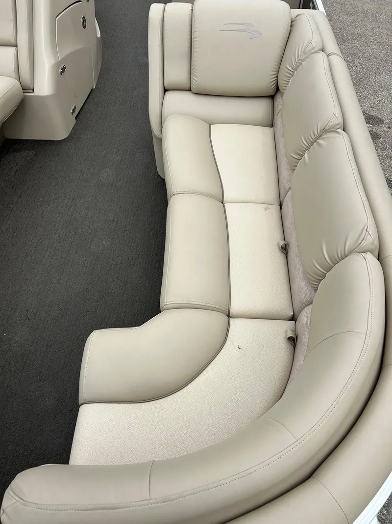 Slide: The Image of 2014 Bennington 2550 RCL boat interior with beige leather seating. - 20