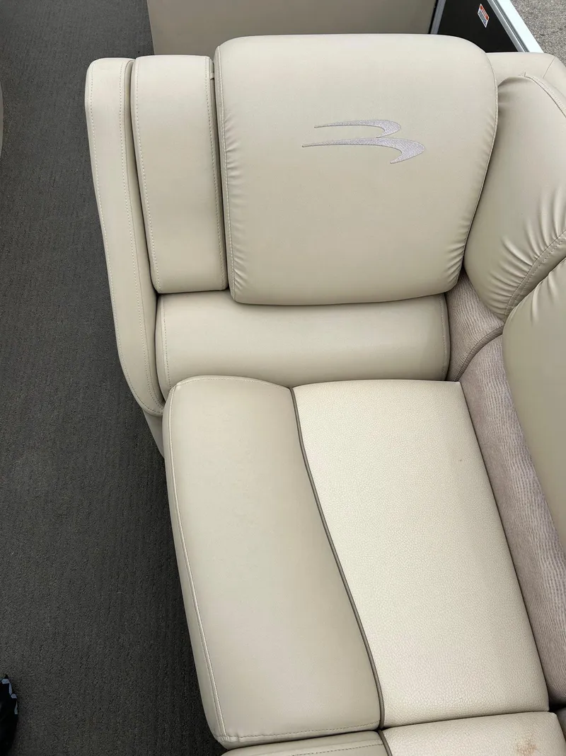 Slide: The Image of Beige leather seating on 2014 Bennington 2550 RCL boat, featuring embroidered logo. - 23
