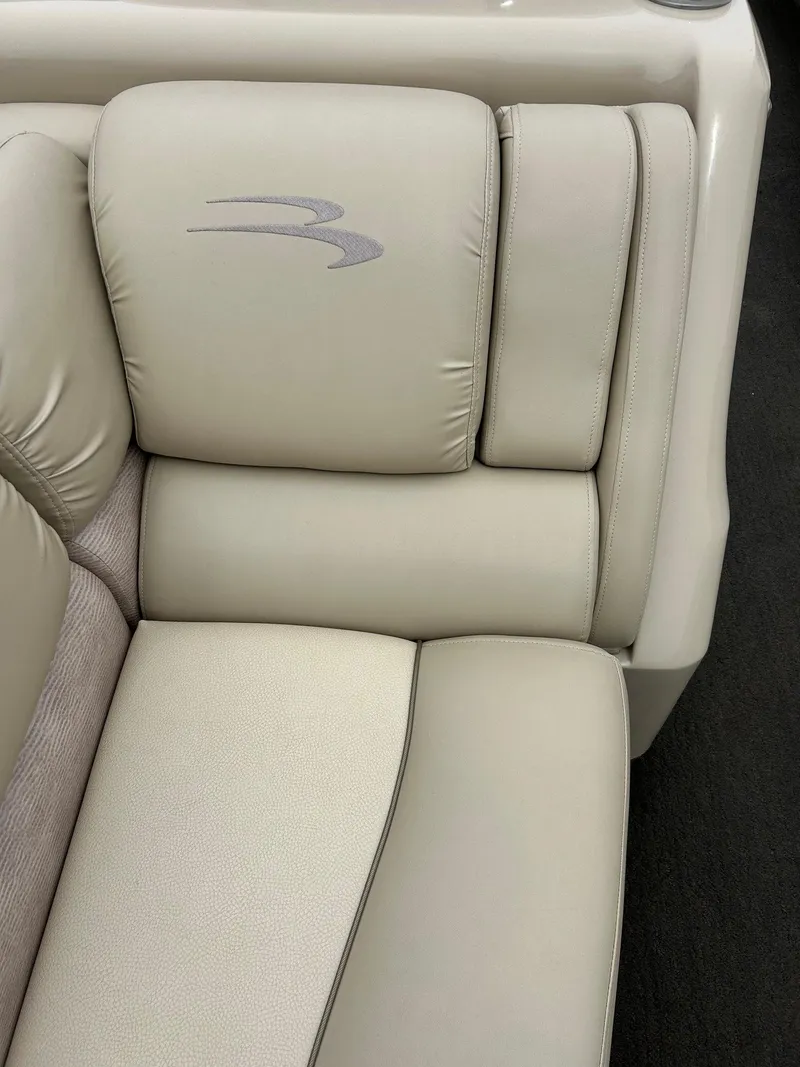 Slide: The Image of 2014 Bennington 2550 RCL boat seat with beige upholstery and logo detail. - 26