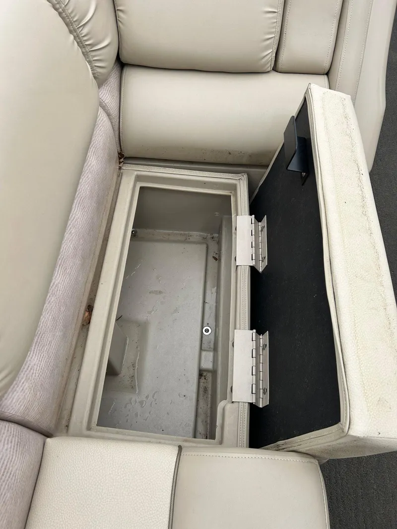 Slide: The Image of 2014 Bennington 2550 RCL boat seat storage compartment, open and empty. - 28