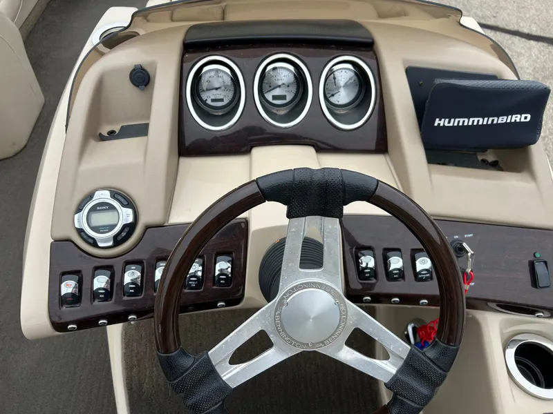 Slide: The Image of 2014 Bennington 2550 RCL boat dashboard with steering wheel and control panel. - 31