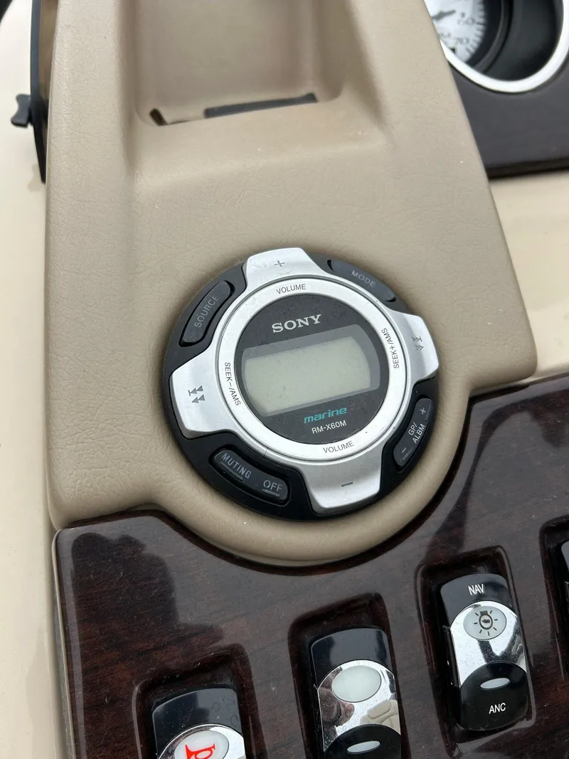 Slide: The Image of 2014 Bennington 2550 RCL boat dashboard with Sony marine audio system controls. - 32