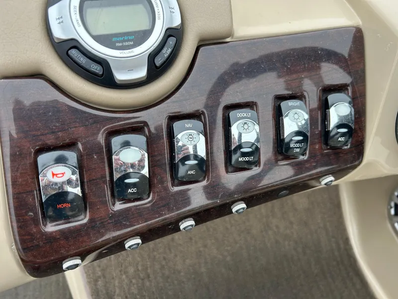 Slide: The Image of Dashboard controls of a 2014 Bennington 2550 RCL boat with various switches and buttons. - 33