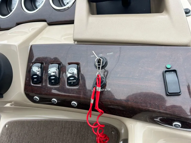 Slide: The Image of Control panel of a 2014 Bennington 2550 RCL boat with ignition and switches. - 34