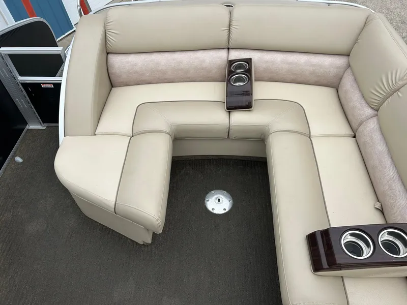 Slide: The Image of 2014 Bennington 2550 RCL boat interior with beige seating and cup holders. - 39
