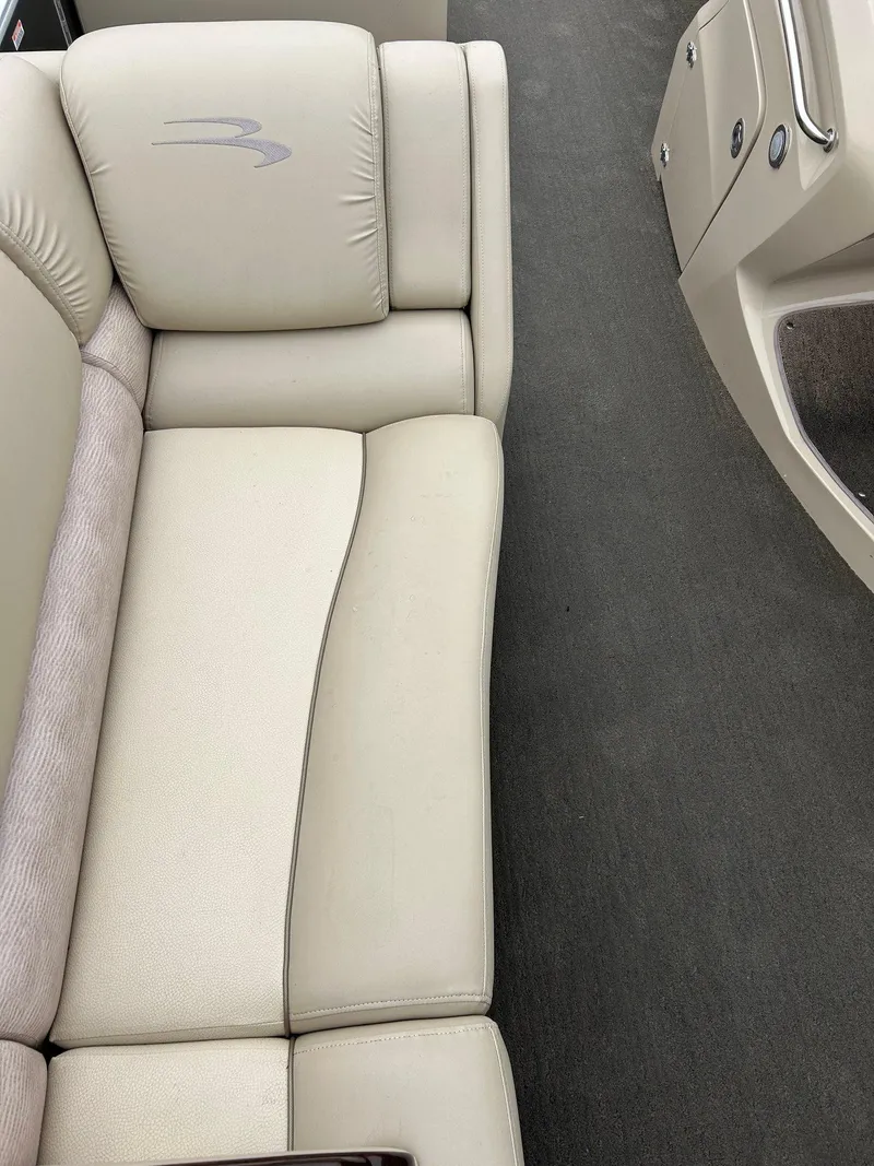 Slide: The Image of 2014 Bennington 2550 RCL boat interior with beige seating and carpeted floor. - 41