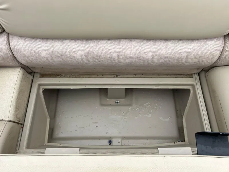 Slide: The Image of 2014 Bennington 2550 RCL boat storage compartment with beige upholstery. - 44