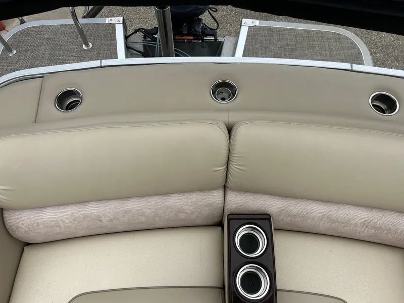 Slide: The Image of 2014 Bennington 2550 RCL boat interior with beige seating and cup holders. - 45