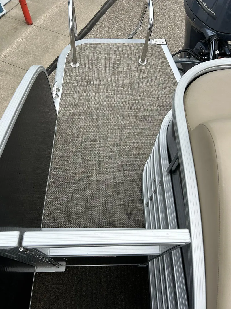 Slide: The Image of 2014 Bennington 2550 RCL boat deck with ladder and seating area. - 48