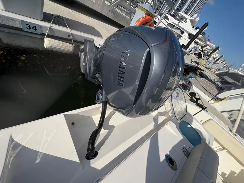 Slide: The Image of 2023 Cobia 237 CC boat with Yamaha outboard motor at marina dock. - 10