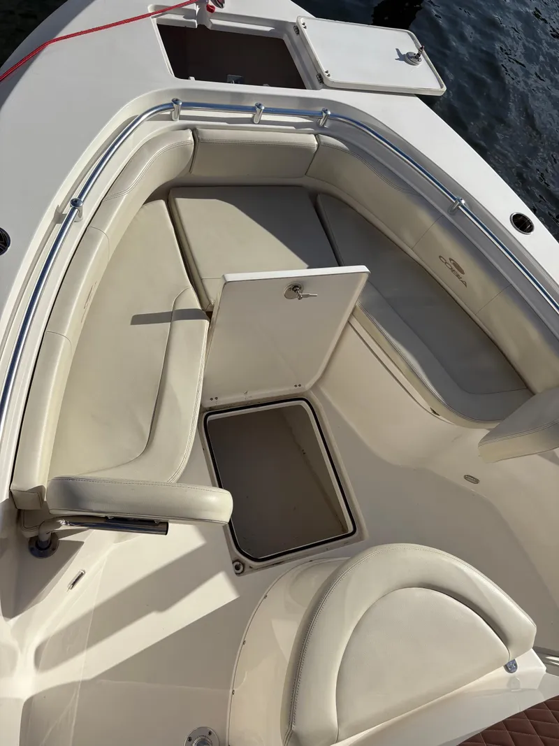 Slide: The Image of 2023 Cobia 237 CC boat interior with cushioned seating and storage compartments. - 6
