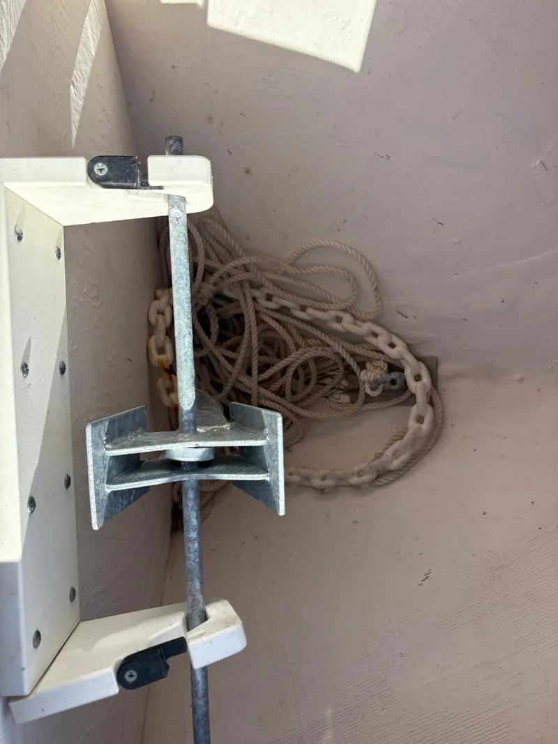 Slide: The Image of Anchor storage compartment on 2023 Cobia 237 CC boat with rope and chain. - 7