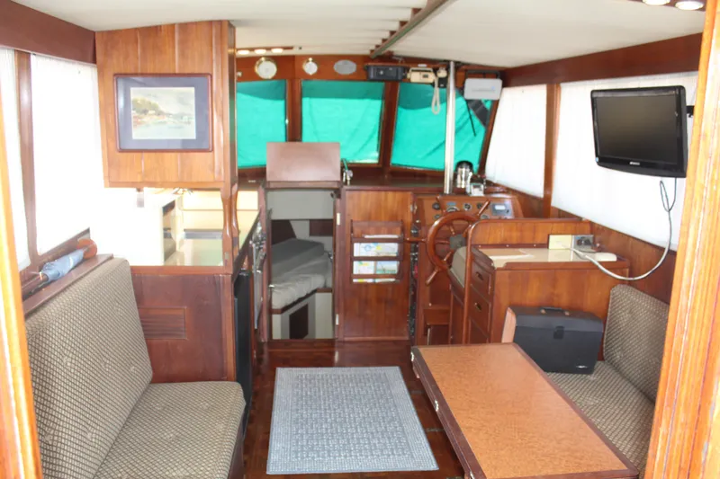 Slide: The Image of Interior of a 1978 Grand Banks 32 boat with wood paneling and seating area. - 16