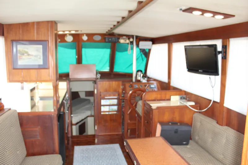 Slide: The Image of Interior of a 1978 Grand Banks 32 boat with wood paneling and seating area. - 17