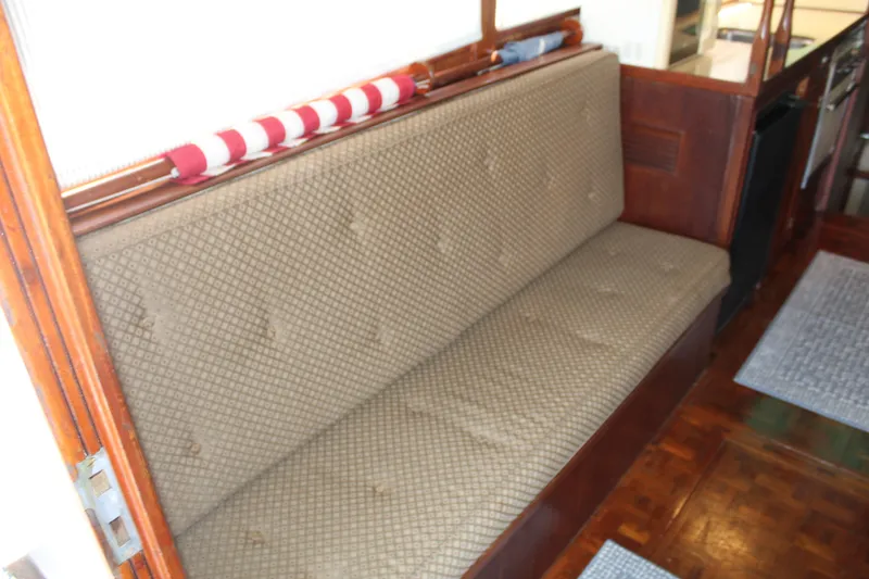 Slide: The Image of 1978 Grand Banks 32 interior with patterned bench seating and wooden accents. - 19
