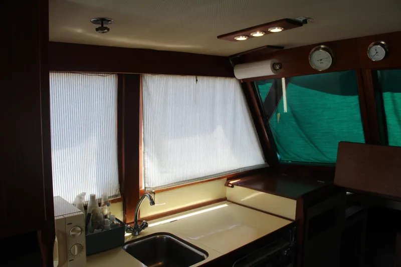 Slide: The Image of Interior of a 1978 Grand Banks 32 boat with kitchen sink and windows. - 28