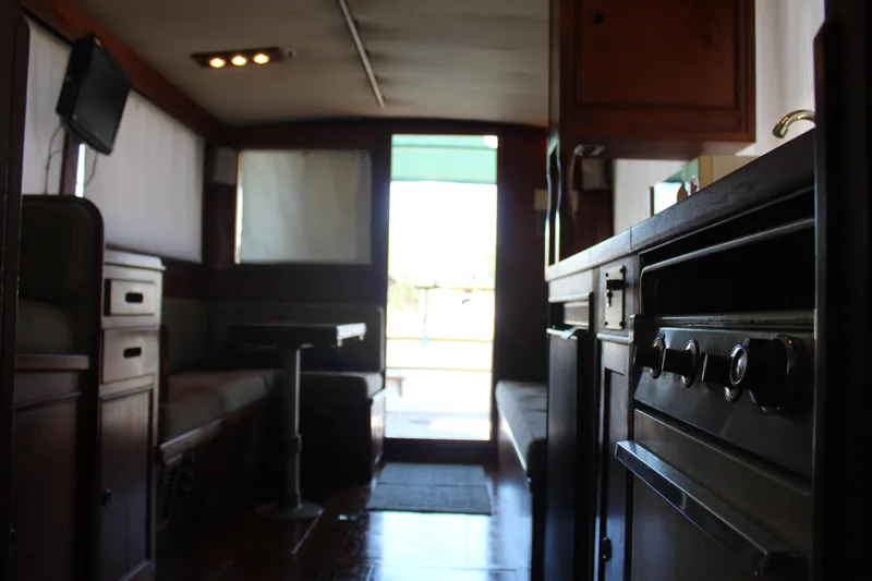 Slide: The Image of Interior of a 1978 Grand Banks 32 boat, featuring a cozy cabin and kitchen area. - 33
