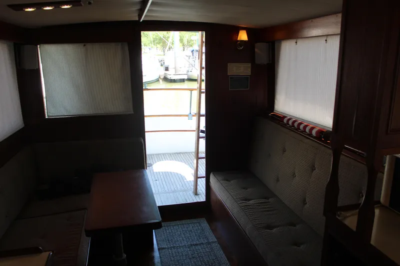 Slide: The Image of Interior of a 1978 Grand Banks 32 boat with seating and natural light. - 36