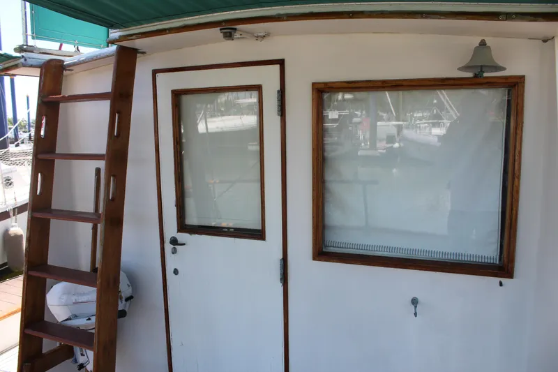 Slide: The Image of 1978 Grand Banks 32 boat exterior with wooden ladder and door. - 37