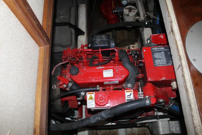 Slide: The Image of Engine compartment of a 1978 Grand Banks 32 boat, featuring a red engine. - 38