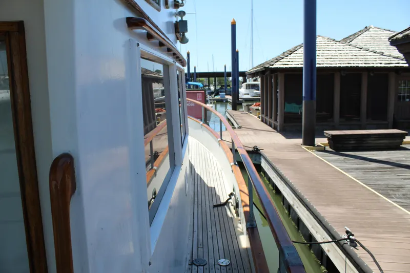Slide: The Image of 1978 Grand Banks 32 yacht docked at a marina with wooden walkways. - 5
