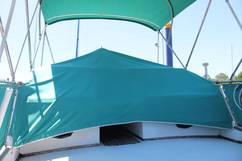 Slide: The Image of 1978 Grand Banks 32 boat with teal canopy and covered deck area. - 7