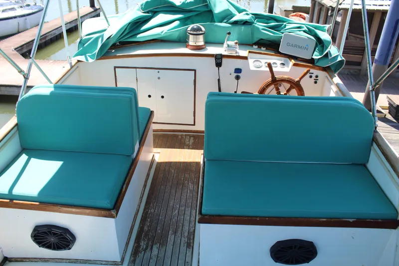 Slide: The Image of 1978 Grand Banks 32 boat interior with teal seating and wooden accents. - 8
