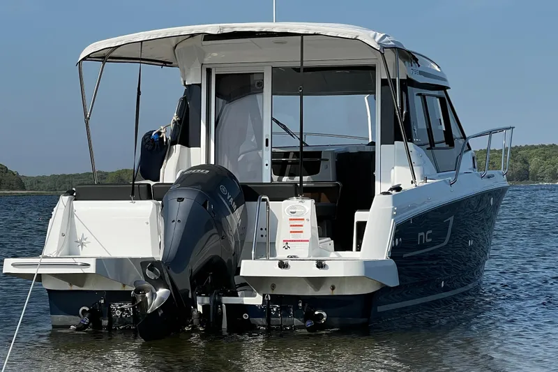 Slide: The Image of 2019 Jeanneau NC 795 boat with outboard motor on calm water. - 2