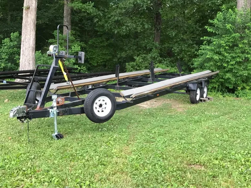 Slide: The Image of Trailer for boats, Crest Ultra ET 2000 model, parked on grass near trees. - 14