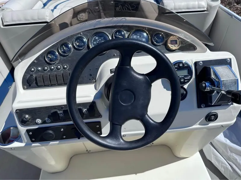 Slide: The Image of Steering console of a 2000 Crest Ultra ET boat with gauges and controls. - 4