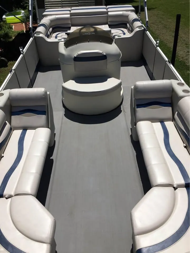 Slide: The Image of 2000 Crest Ultra ET pontoon boat with spacious seating and modern design. - 6