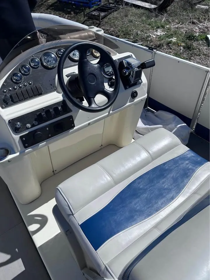 Slide: The Image of Steering console of a 2000 Crest Ultra ET boat with gauges and seating. - 7