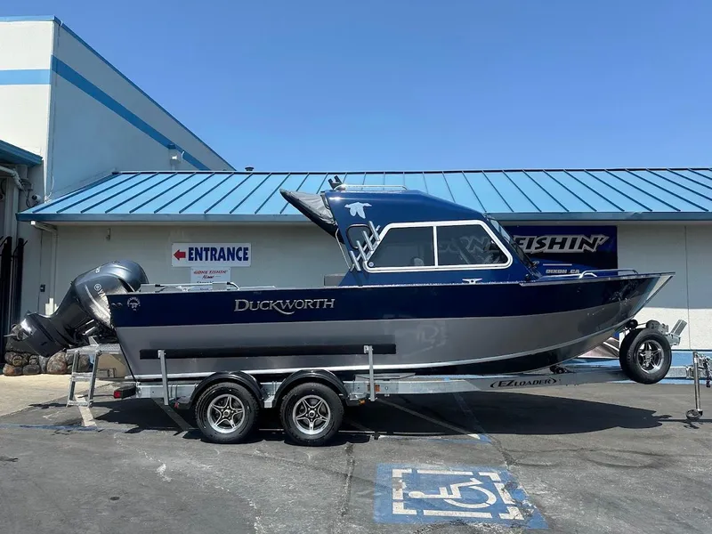 Slide: The Image of 2025 Duckworth 21 Discovery boat on trailer outside a building. - 0