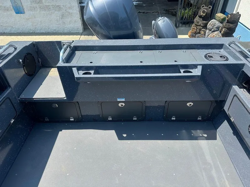 Slide: The Image of 2025 Duckworth 21 Discovery boat interior with storage compartments and motor. - 13