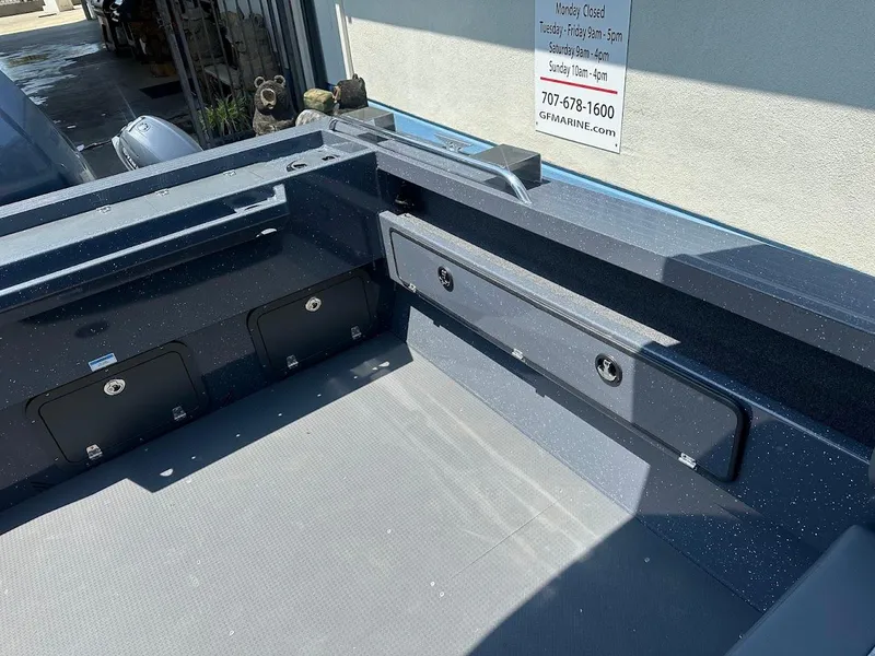 Slide: The Image of 2025 Duckworth 21 Discovery boat interior with storage compartments and clean deck. - 14