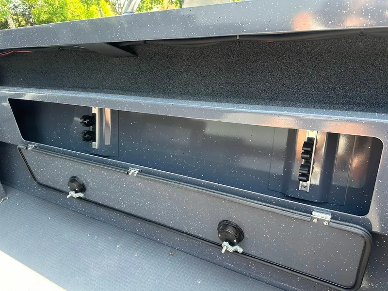 Slide: The Image of 2025 Duckworth 21 Discovery boat storage compartment with secure latches and sleek design. - 16