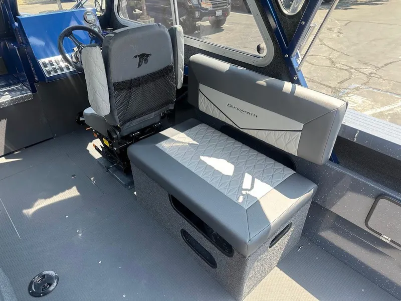 Slide: The Image of Interior of 2025 Duckworth 21 Discovery boat with seating and steering wheel. - 18