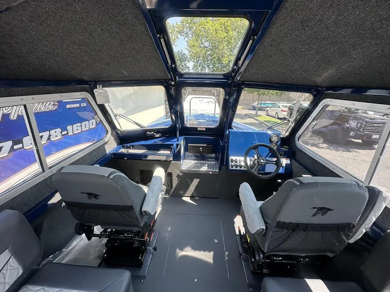 Slide: The Image of Interior of 2025 Duckworth 21 Discovery boat with modern seating and steering console. - 19