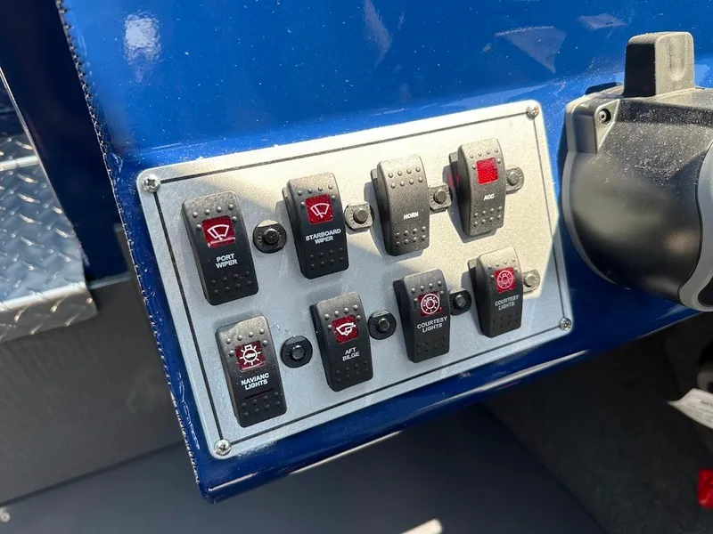Slide: The Image of Control panel of a 2025 Duckworth 21 Discovery boat with various switches. - 23
