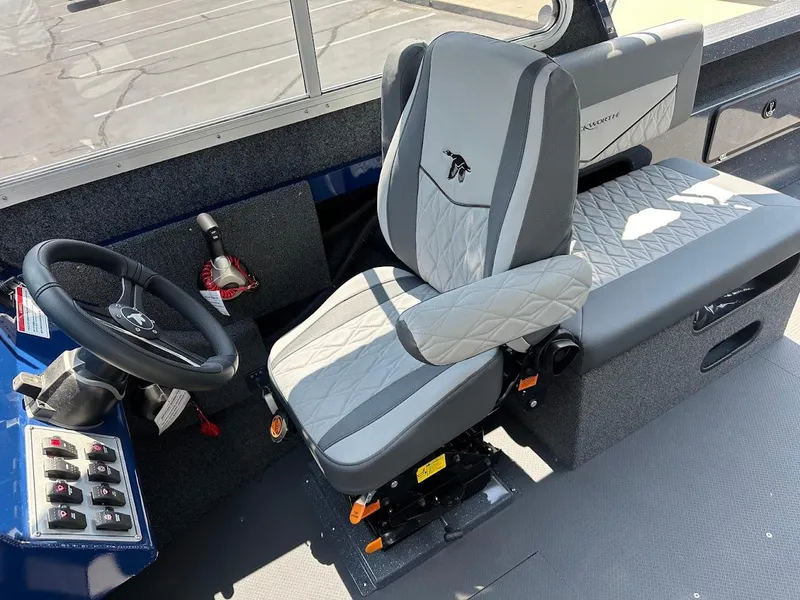 Slide: The Image of Interior of 2025 Duckworth 21 Discovery boat, featuring a modern captain's seat and steering wheel. - 25