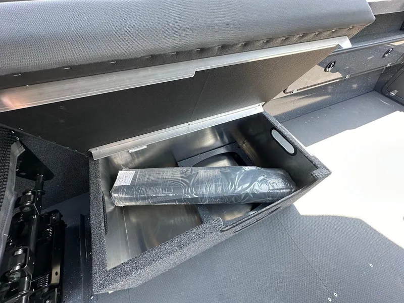 Slide: The Image of Storage compartment in a 2025 Duckworth 21 Discovery boat, featuring a padded interior. - 28