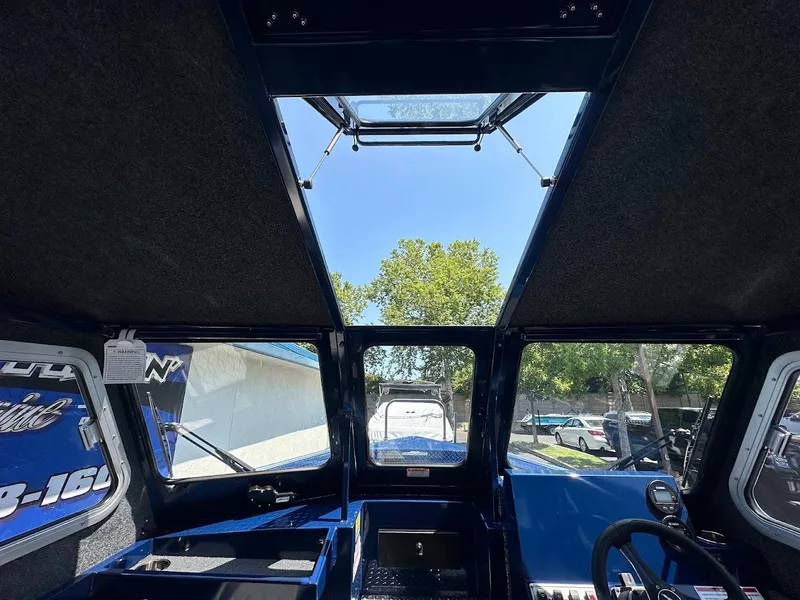 Slide: The Image of Interior view of 2025 Duckworth 21 Discovery boat with sunroof and steering console. - 30