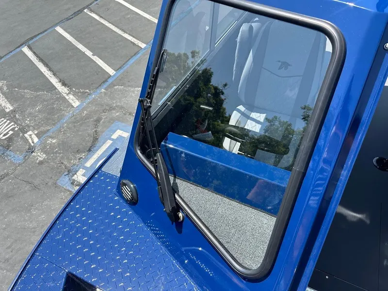 Slide: The Image of Blue 2025 Duckworth 21 Discovery boat with windshield and wiper, parked in a lot. - 32