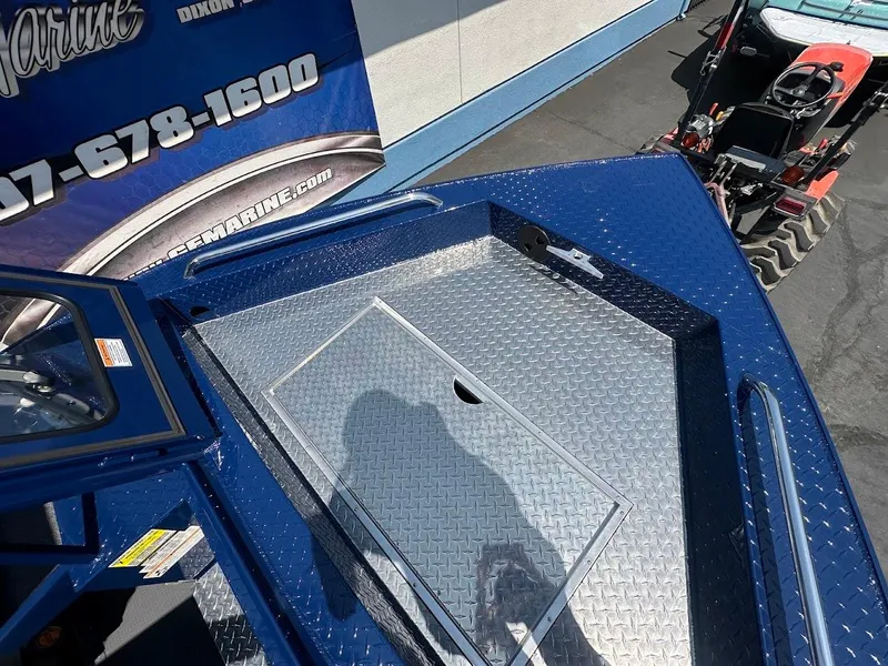 Slide: The Image of 2025 Duckworth 21 Discovery boat with diamond plate deck, displayed outdoors. - 33