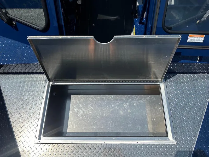 Slide: The Image of Open storage compartment on 2025 Duckworth 21 Discovery boat, featuring diamond plate flooring. - 34