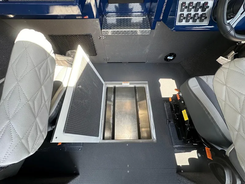 Slide: The Image of 2025 Duckworth 21 Discovery interior with open storage compartment and diamond-stitched seats. - 35