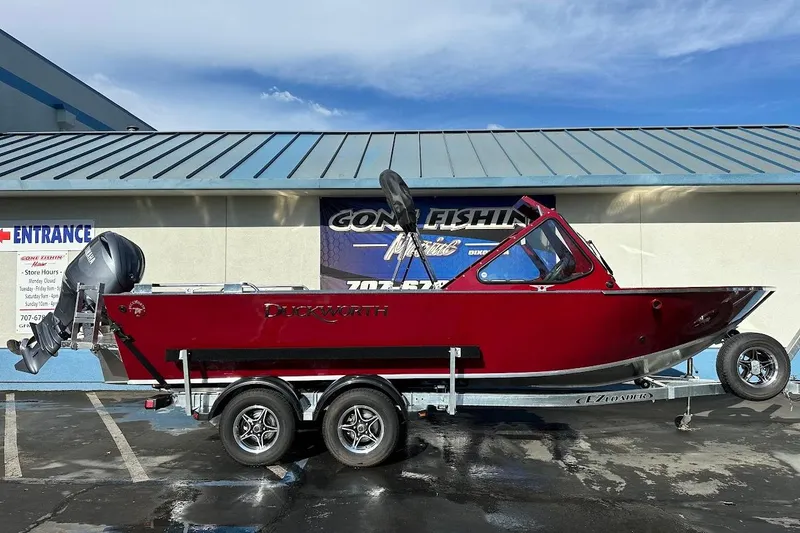 Slide: The Image of 2025 Duckworth 20 Advantage SE boat on trailer, parked outside a building. - 0