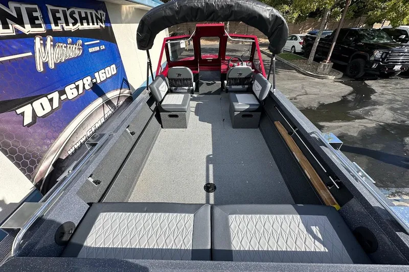 Slide: The Image of 2025 Duckworth 20 Advantage SE boat interior with seating and canopy, displayed at a marine dealership. - 11