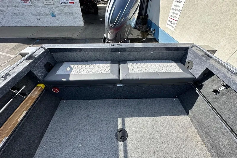 Slide: The Image of 2025 Duckworth 20 Advantage SE boat interior with cushioned seating and motor view. - 15